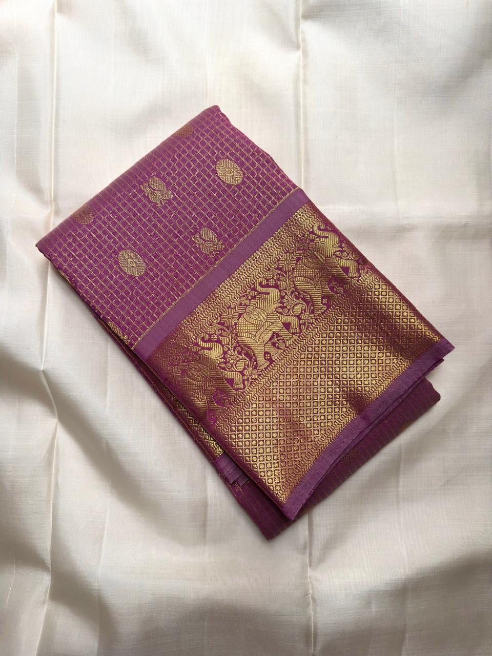 Purple Kanjipuram saree with Mayil motifs and gold zari pallu