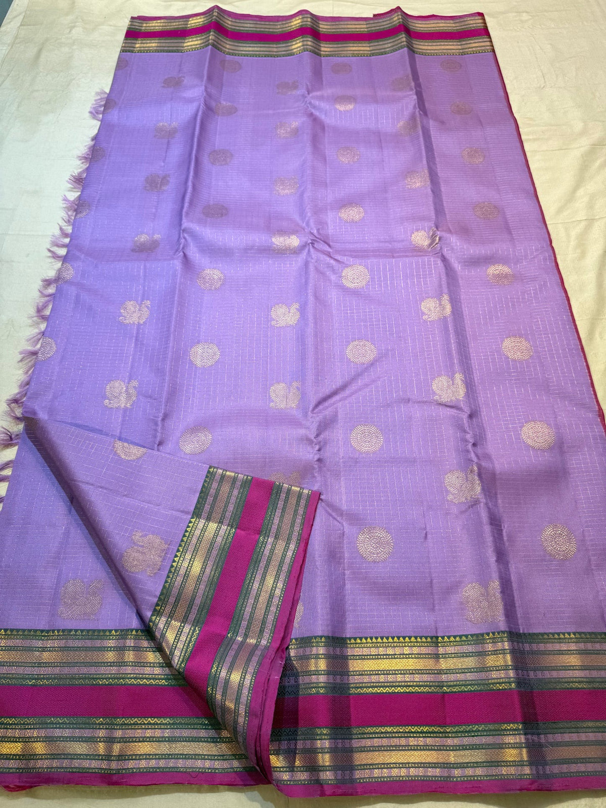 Lavender Purple silk body with alternating traditional zari buttas and delicate checked zari weave.
