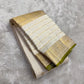 Close detail of fine Zari Kattam gold grid across the pearl ivory silk body.