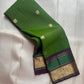 Close-up of antique gold zari Butta motifs on leaf green Kanjivaram silk saree