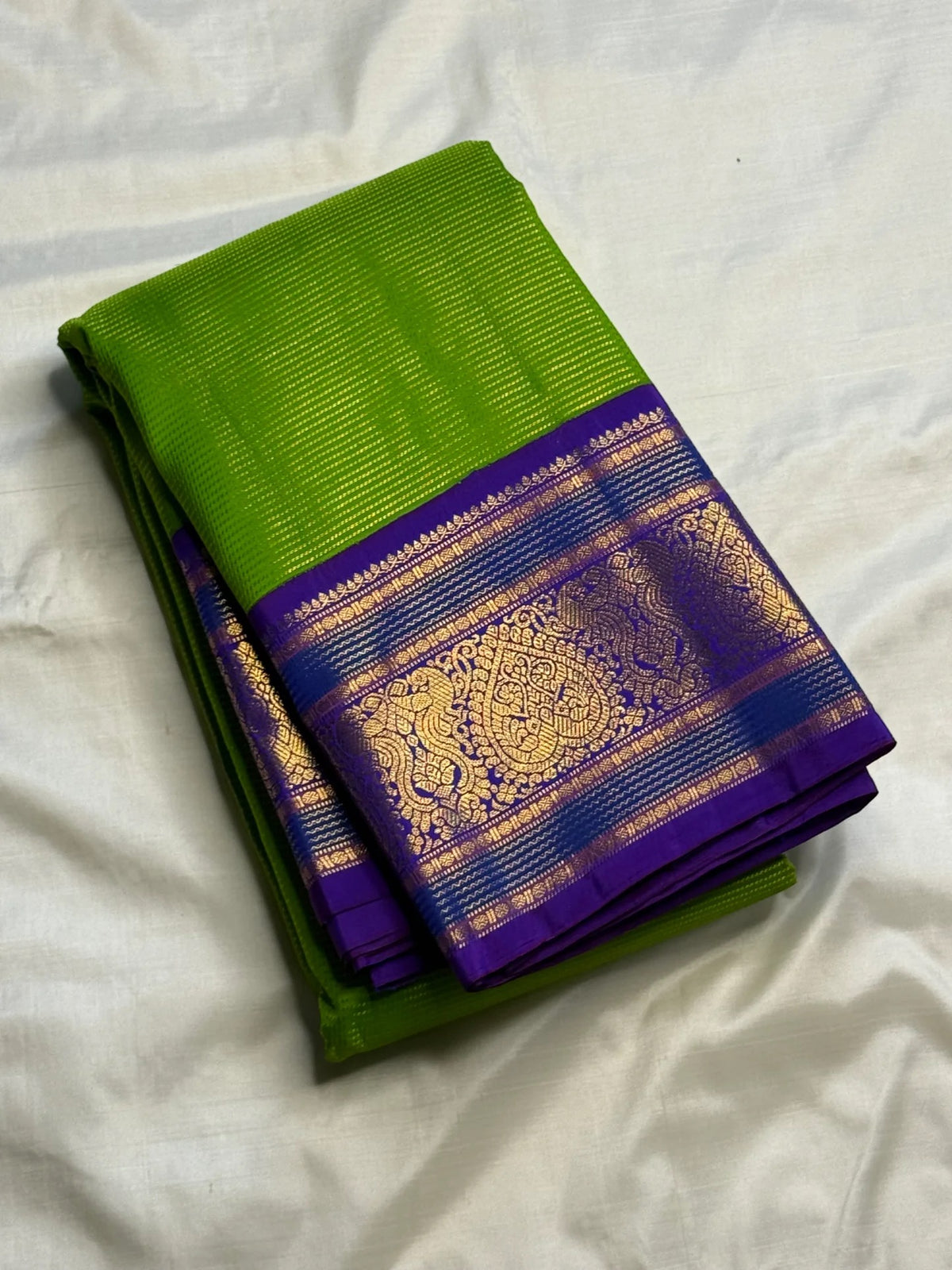 Handwoven Korvai saree with Royal Purple contrast border and antique-gold paisley forms.