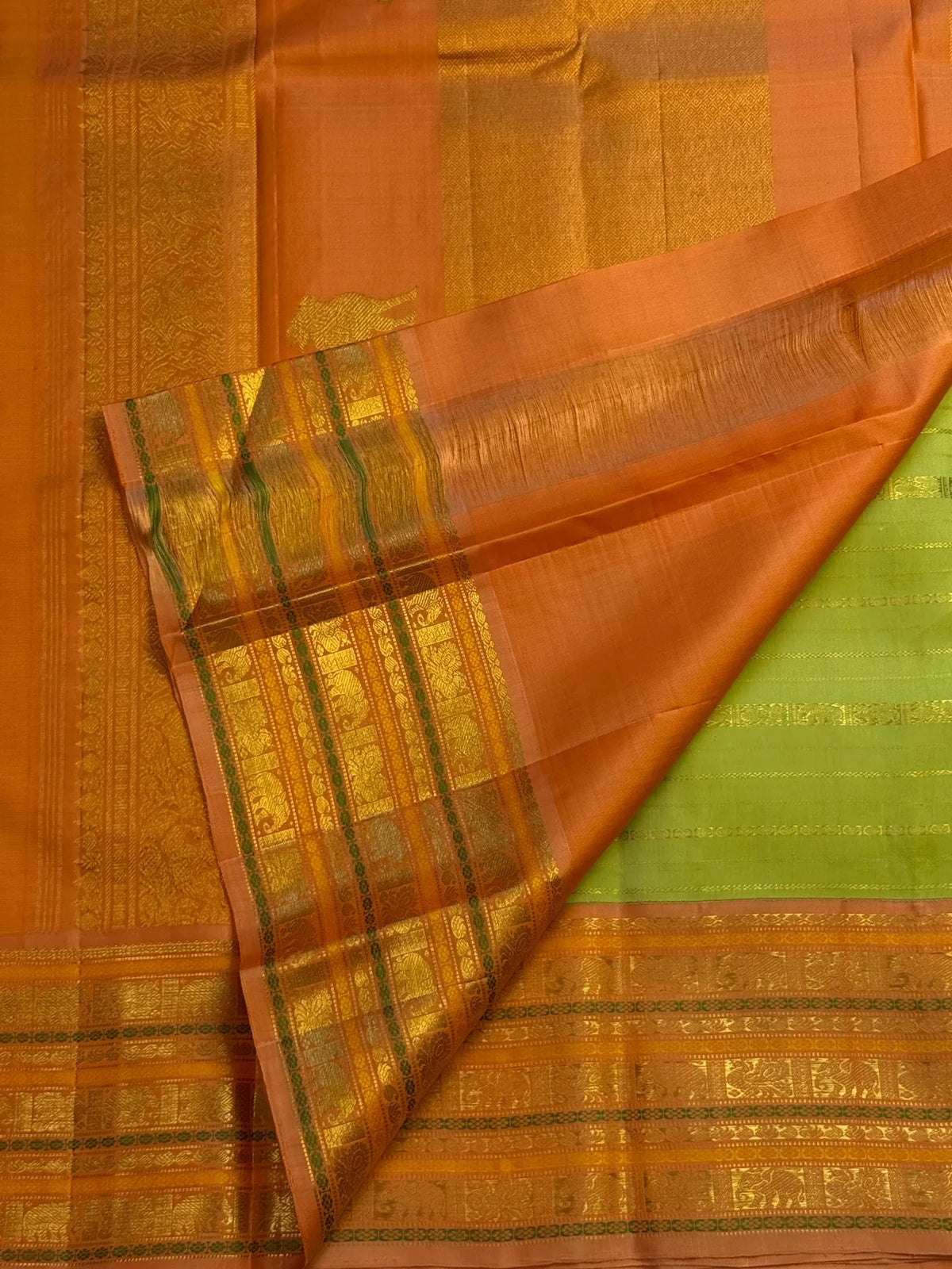 Luminous Vairaoosi zari stripes across a soft green handwoven Kanchipuram silk saree.