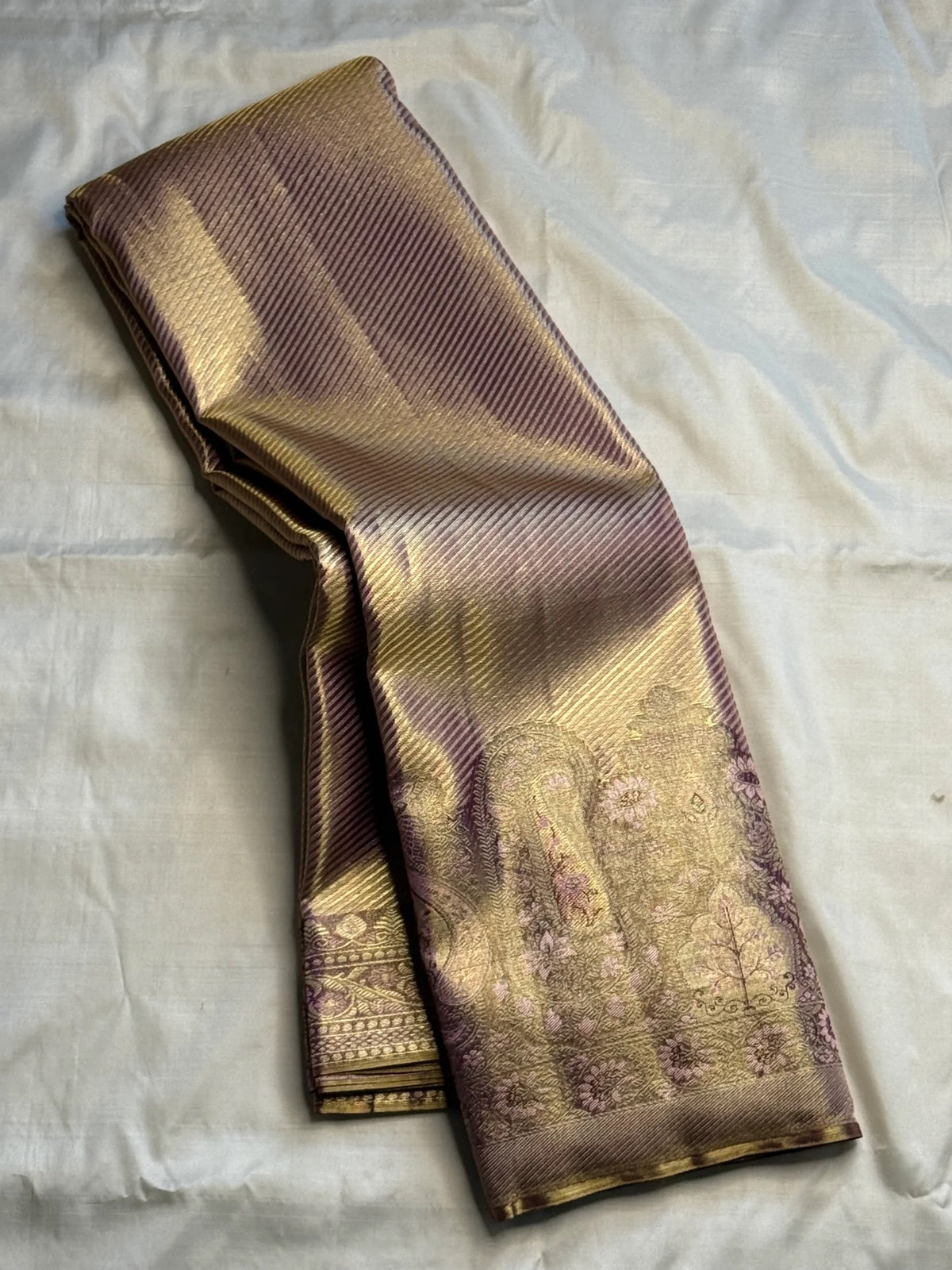 Light lavender-gold Pure Silk Kancheepuram Butta saree with a dense diagonal body and Banarasi-inspired brocade border.