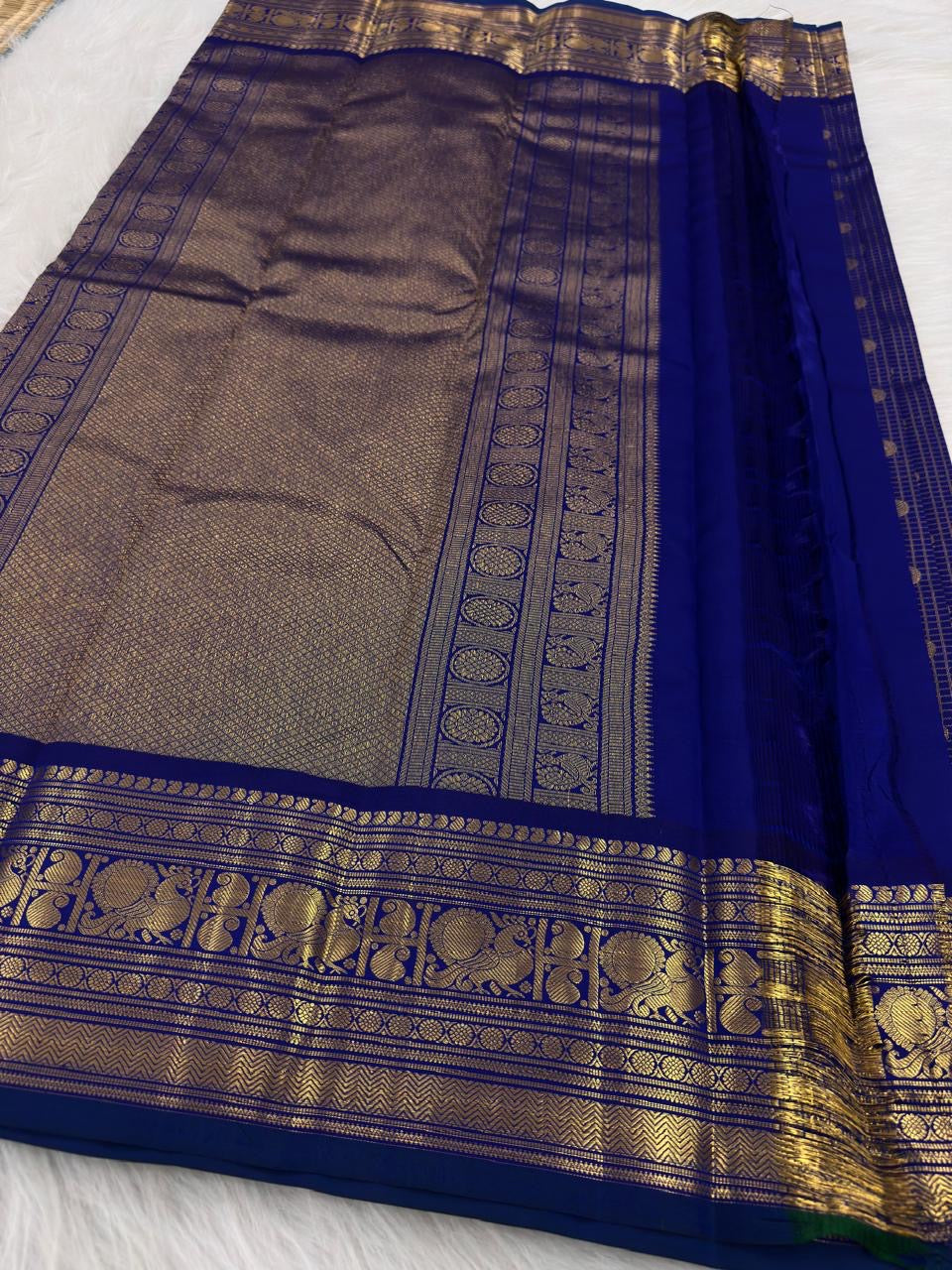 Royal blue Kanjipuram saree, grand gold zari peacock border detail