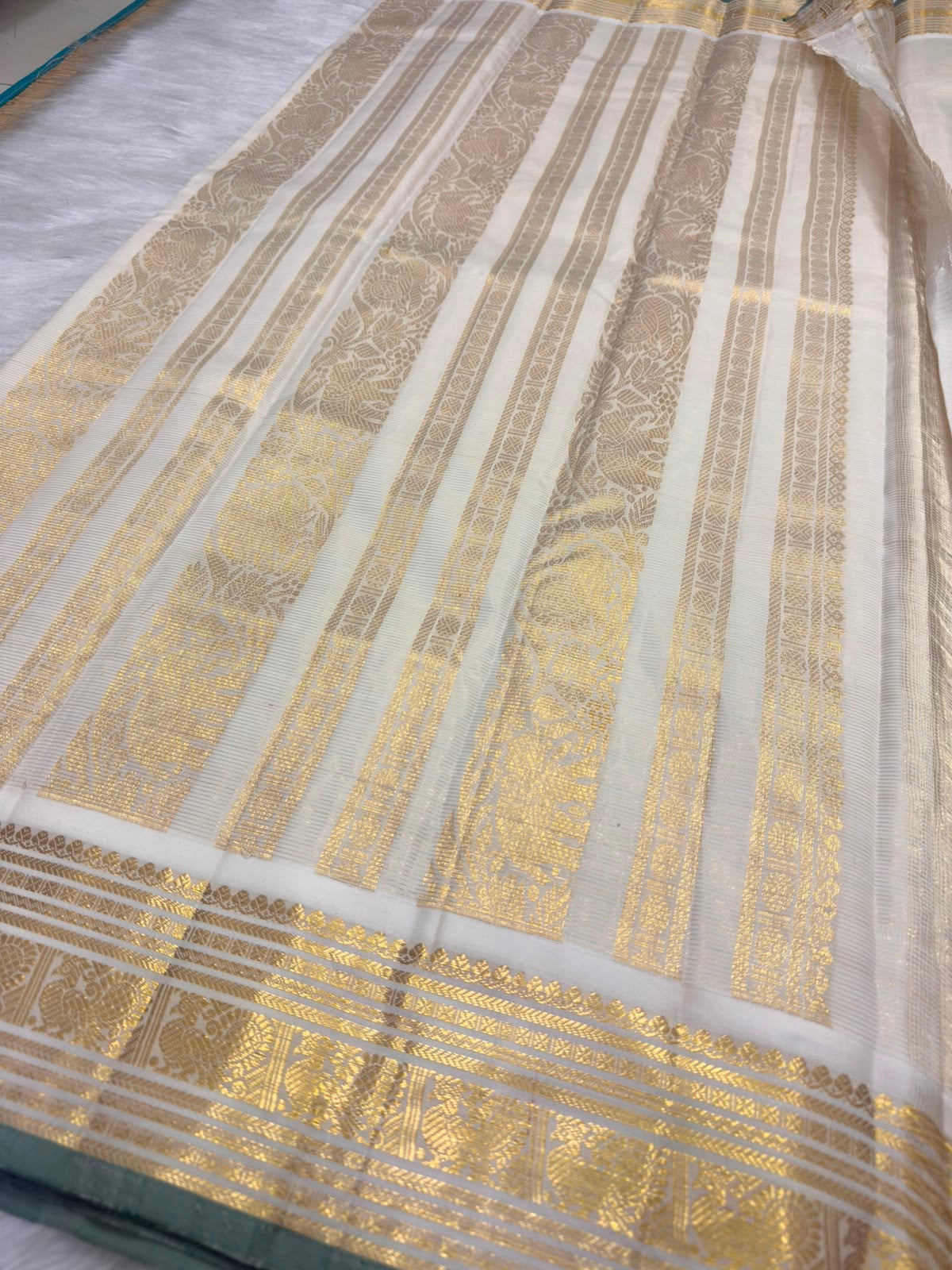 Warm Ivory Pure Silk saree with intricate traditional gold zari border