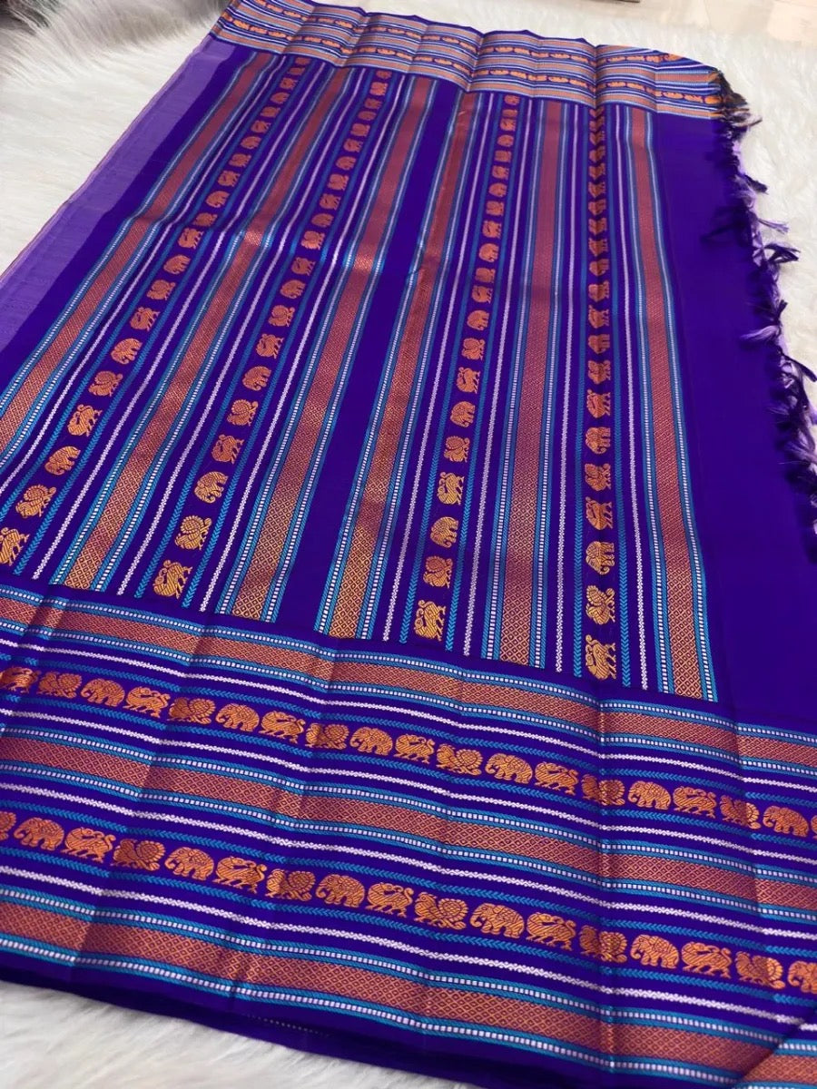 Royal-purple Pattupet border with silk-thread elephant motifs.