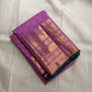 Lilac Kanchipuram silk saree with dark leaf-green edge, folded to show the Varisaipet border and pallu