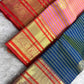 Gold zari floral and Banarasi-inspired decorative motifs across the traditional Kanchipuram contrast border.