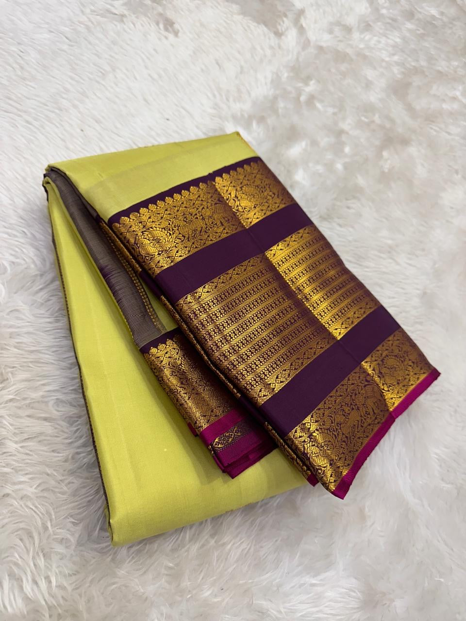 Handwoven pure silk Kanjipuram saree in lime chartreuse with Kudhirai flying horse butta and deep purple Kai Korvai dense antique gold zari border Silk Mark certified