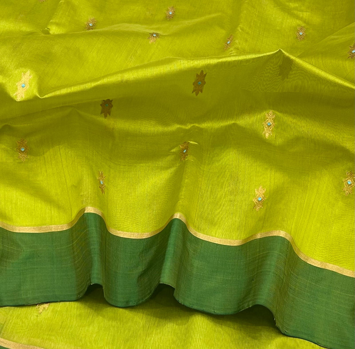 Lime Green handloom Pattu Silk Chanderi saree fully displayed with Forest Green border, gold edging and woven pallu