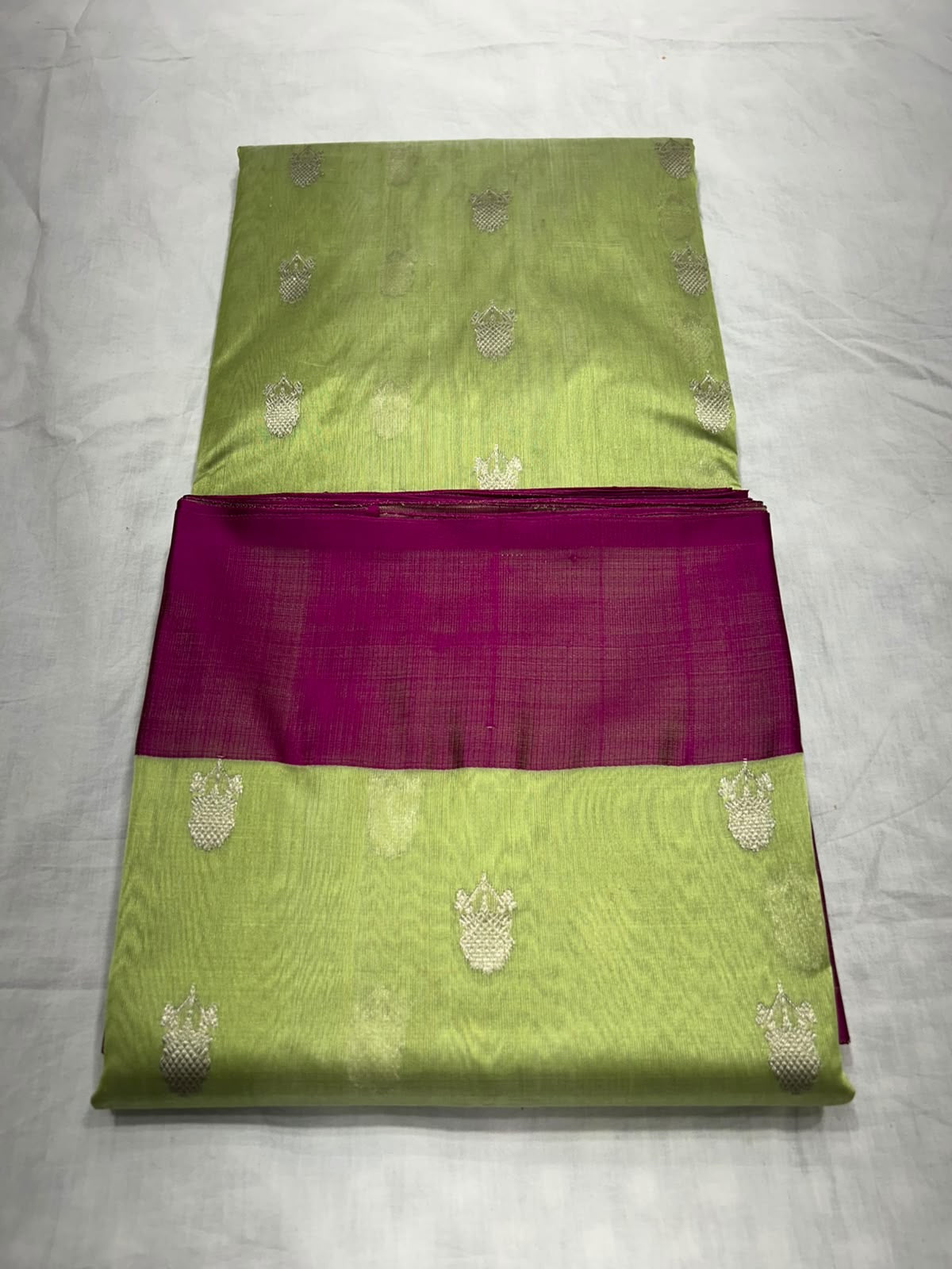 Lime green floral butta Chanderi saree with contrasting magenta borders.