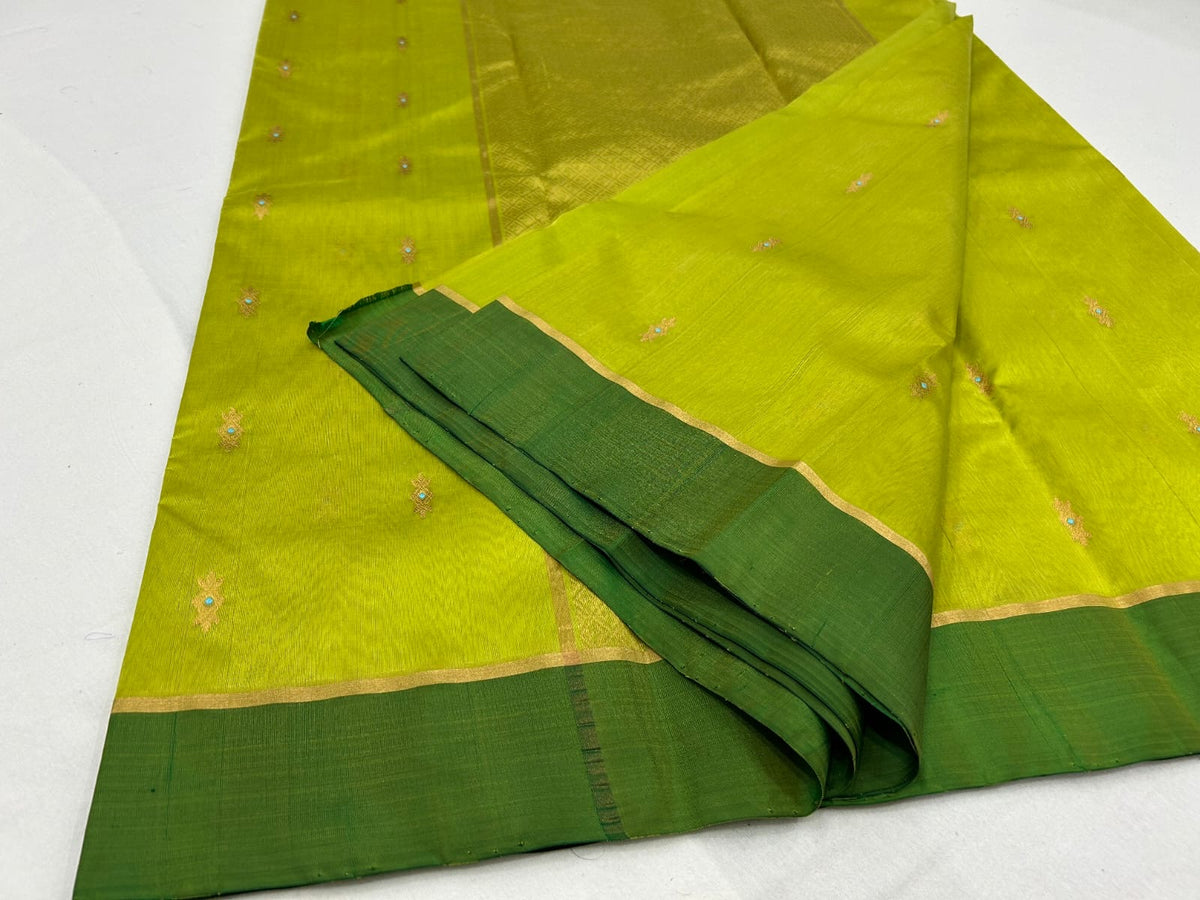 Detail of petite gold woven buttas with tiny turquoise-blue accents on a Lime Green Chanderi silk saree