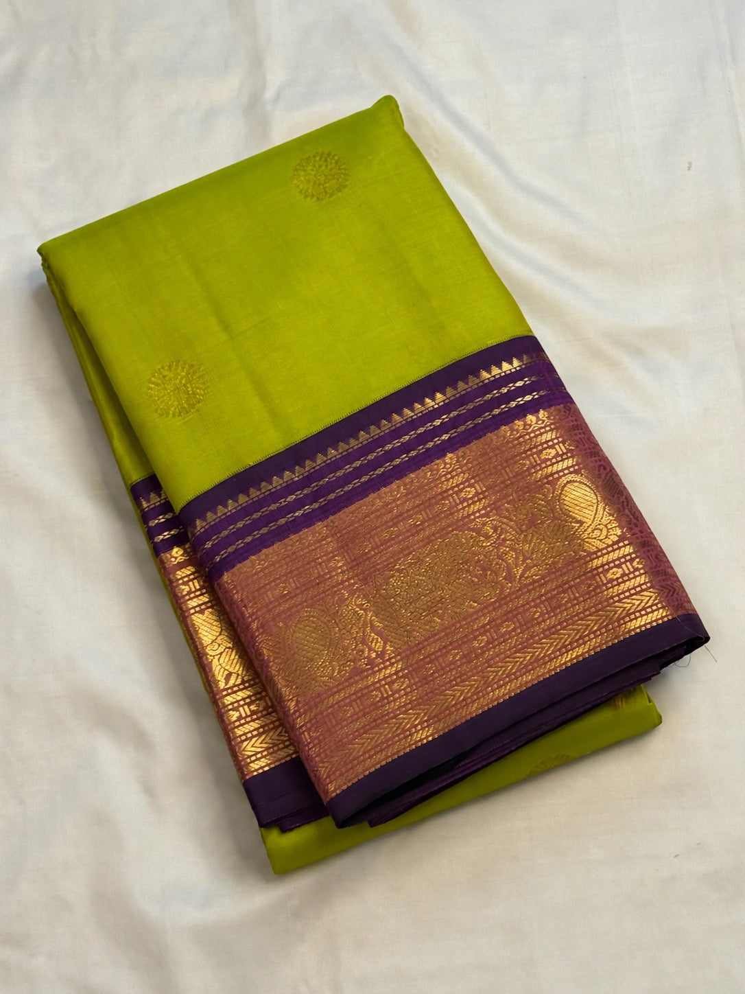 Lime green Kanchipuram pure silk body with gold zari Kamalam buttas, close view