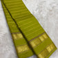 Full view of lime green handwoven Kanchipuram pure silk saree with seepu reku body and rettapet border — Idam Living