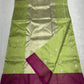 Close-up of small metallic floral buttas on a lime green Chanderi silk saree.