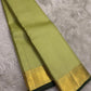 Thick antique gold zari woven border with floral and geometric motifs on pistachio Kanchipuram saree