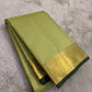 Diagonal zari woven pallu in antique gold cascading across pistachio silk ground