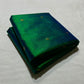 Peacock blue green pure silk Chanderi handloom saree with delicate zari buttas folded on neutral backdrop