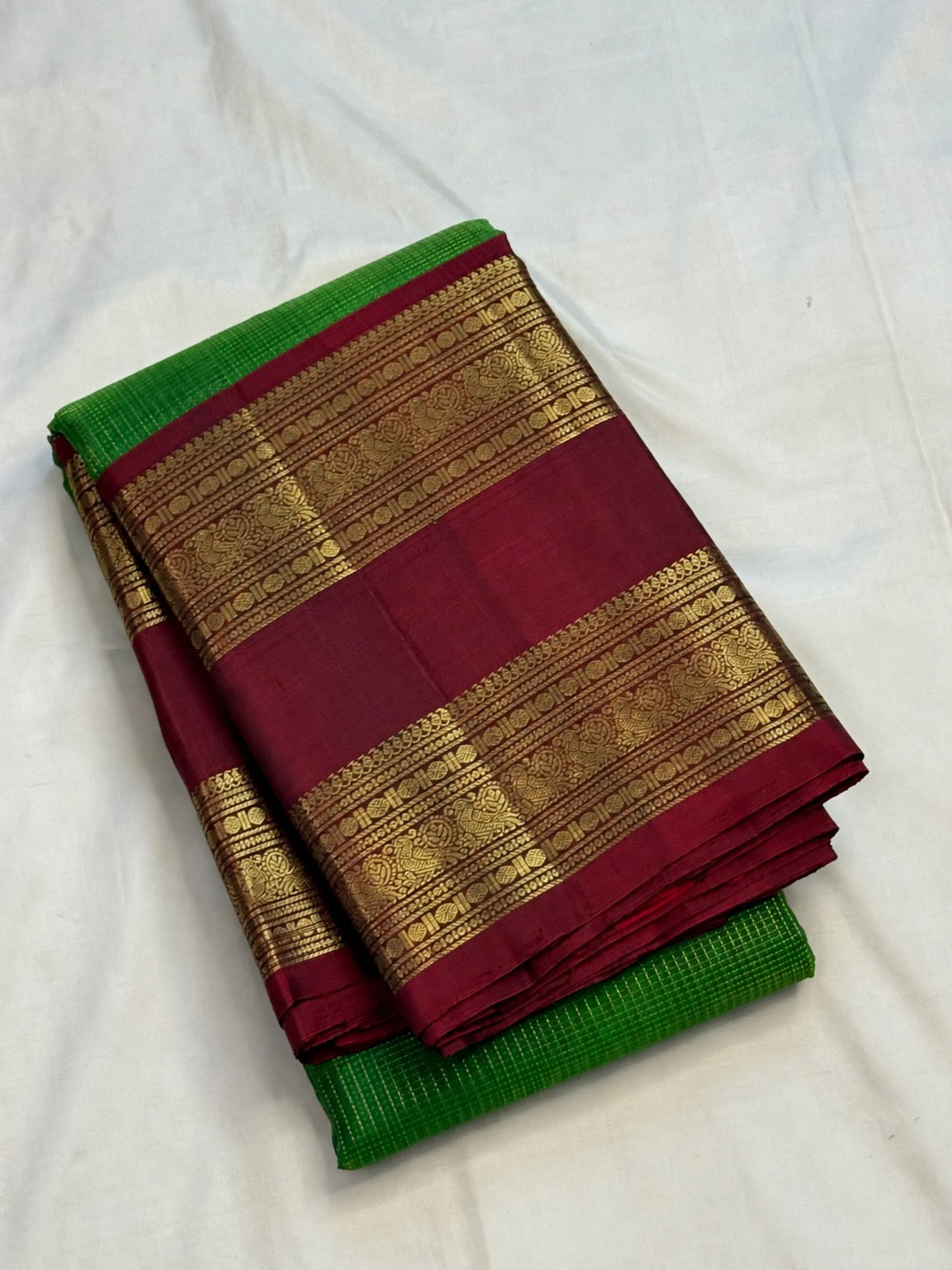 Luminous green Kanchipuram pure silk body with fine gold zari checks, close view