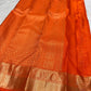 Luminous antique-gold zari border on Radiant Burnt Orange Kanchipuram silk saree.