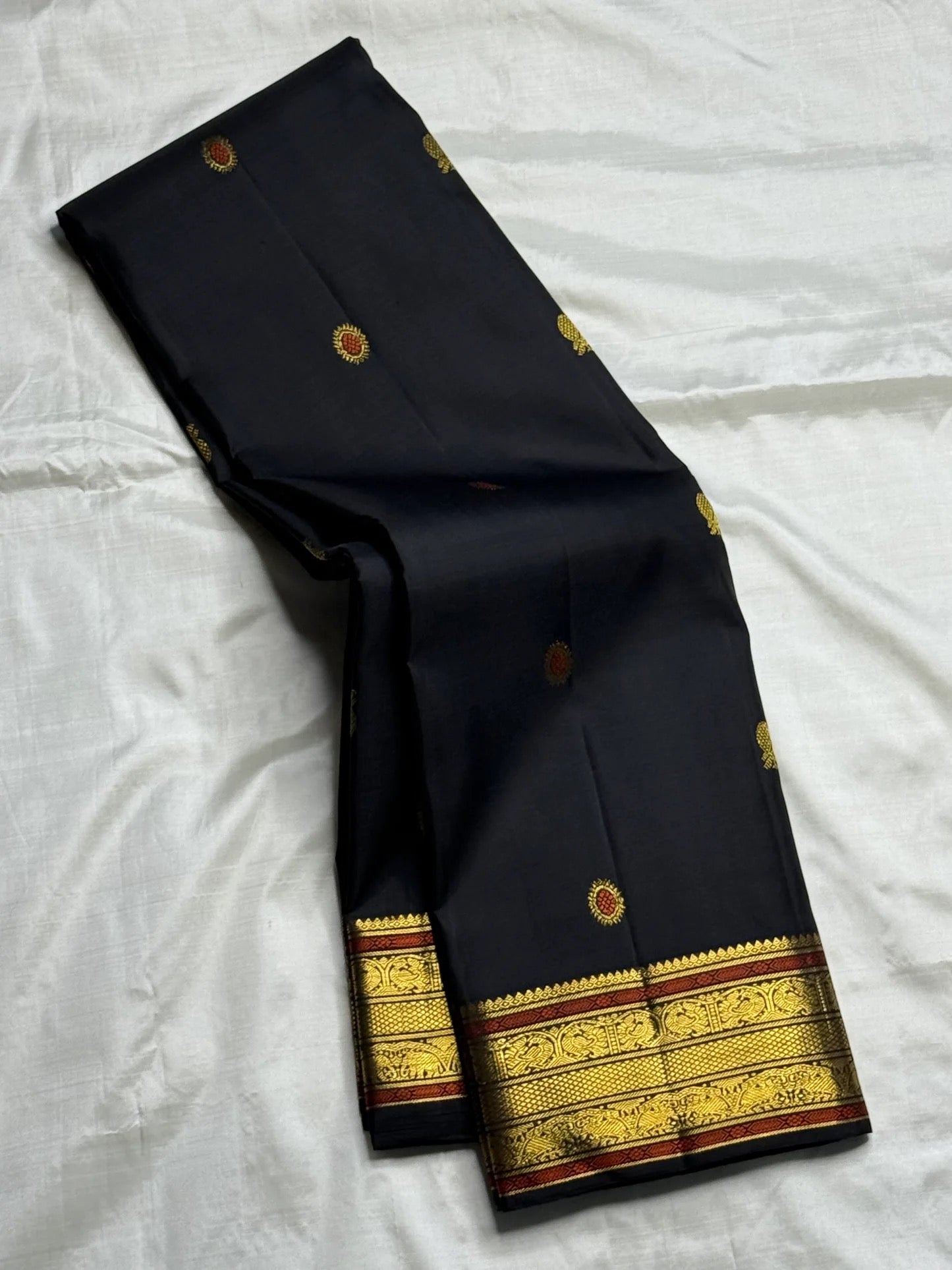 South Indian black silk saree with luminous traditional zari and heirloom-inspired detailing.