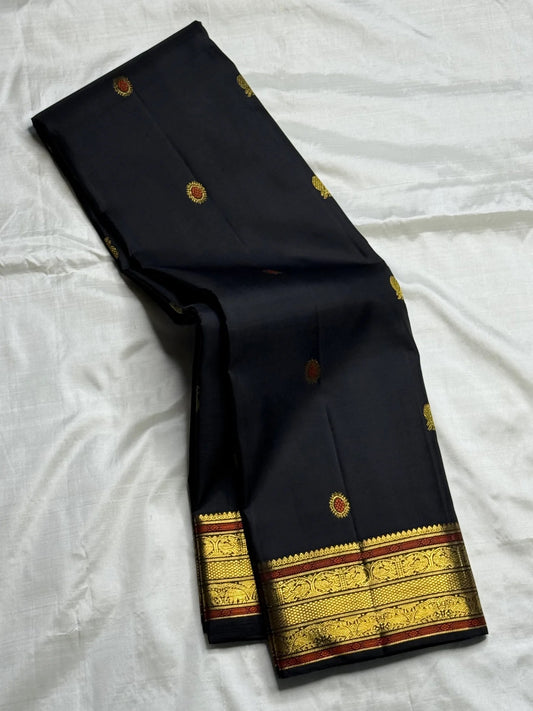 South Indian black silk saree with luminous traditional zari and heirloom-inspired detailing.
