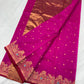 Purplish pink Chanderi saree opened to show the full gold-toned pallu and floral border with turquoise accents