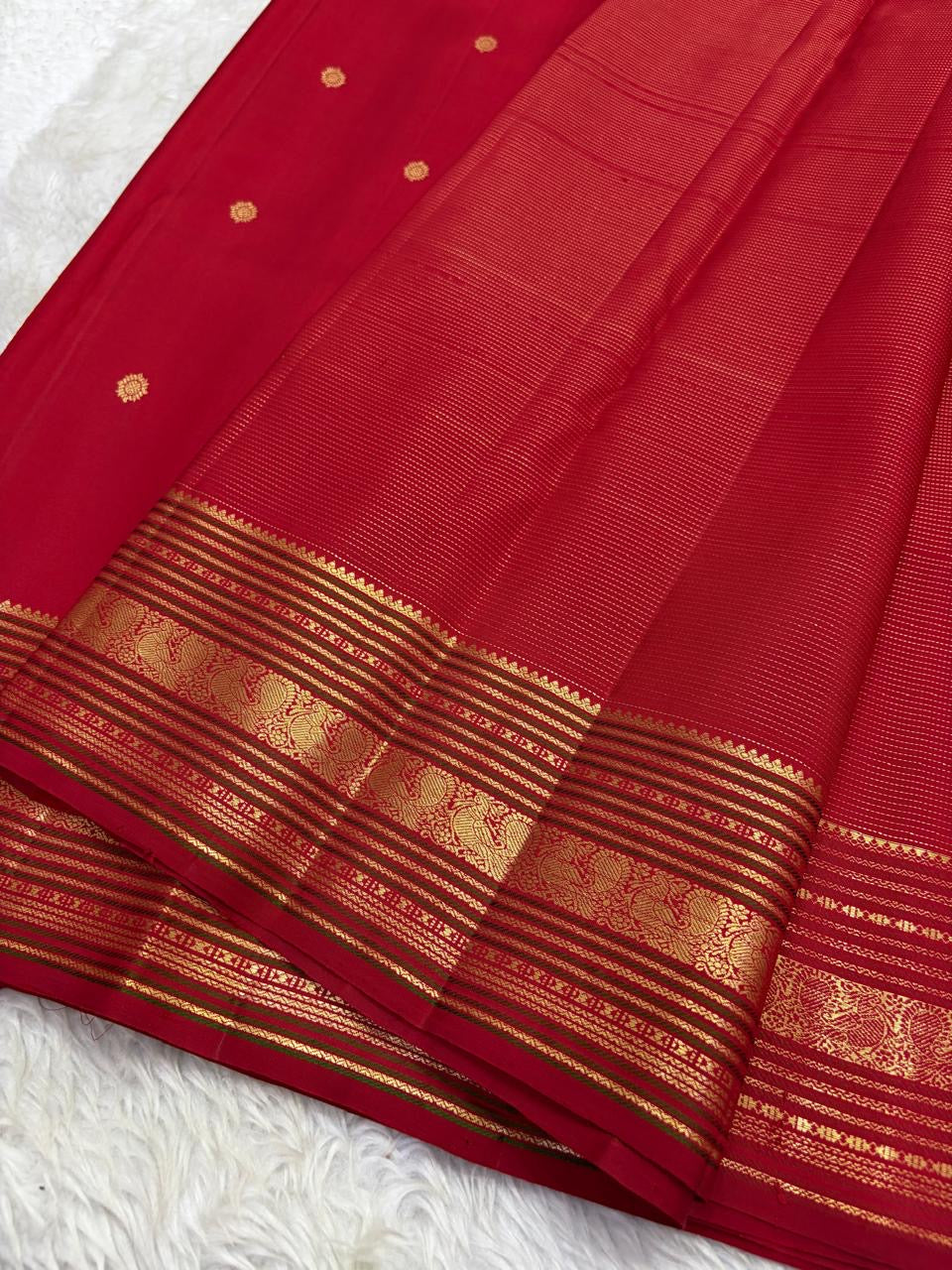 Red Kanchipuram silk saree draped showing vairaoosi weave and gold zari varisaipet border Idam Living