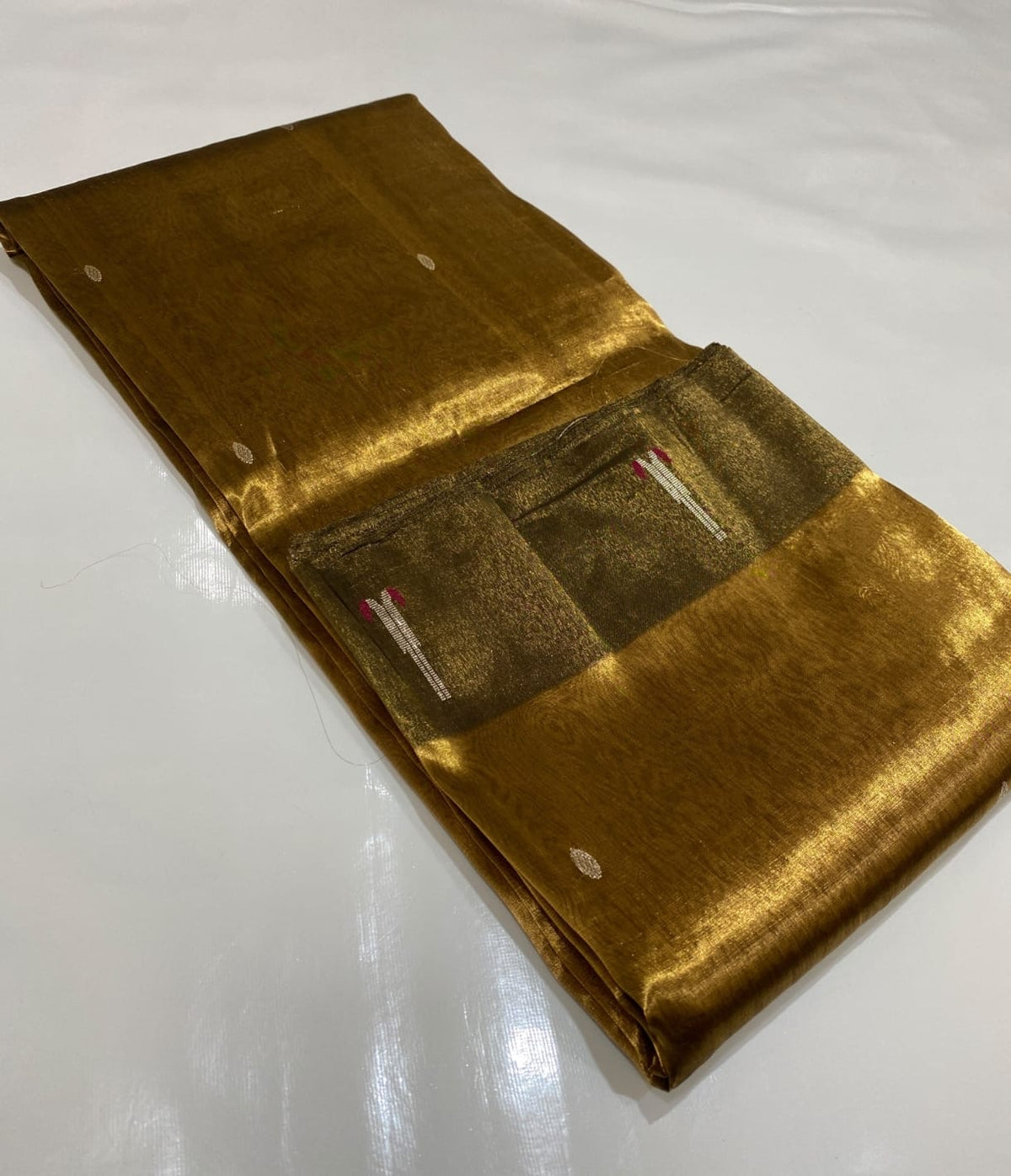 Antique Gold Tissue Silk Chanderi saree showing sheer gold body, olive border, woven buttas and fine striped detailing