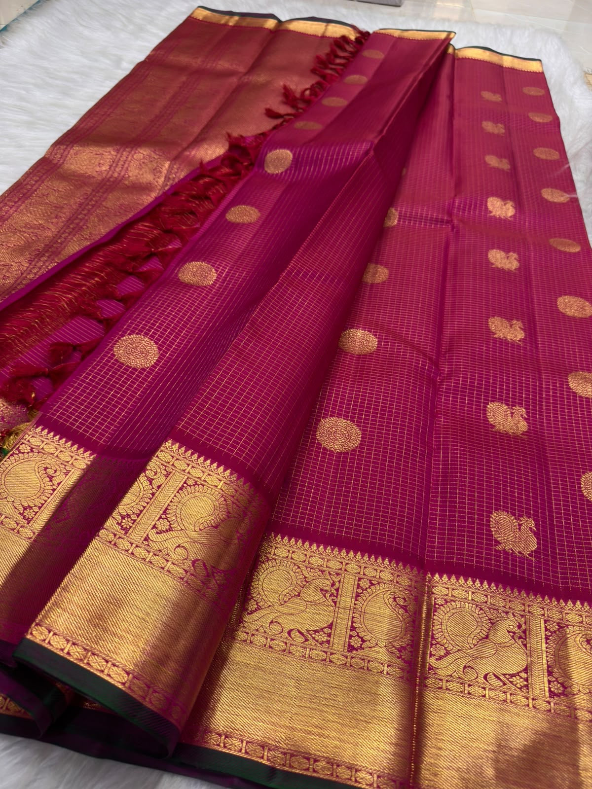 Broad classic-gold Kanchipuram border with large repeating Maanga motifs arranged inside architectural panels.