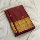Maanga paisley motif on the gold zari border of the Arakku maroon Kanchipuram Vairaoosi saree
