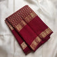 Broad plain Arakku pettu framed by compartmented floral-paisley zari work and fine geometric reku detailing.