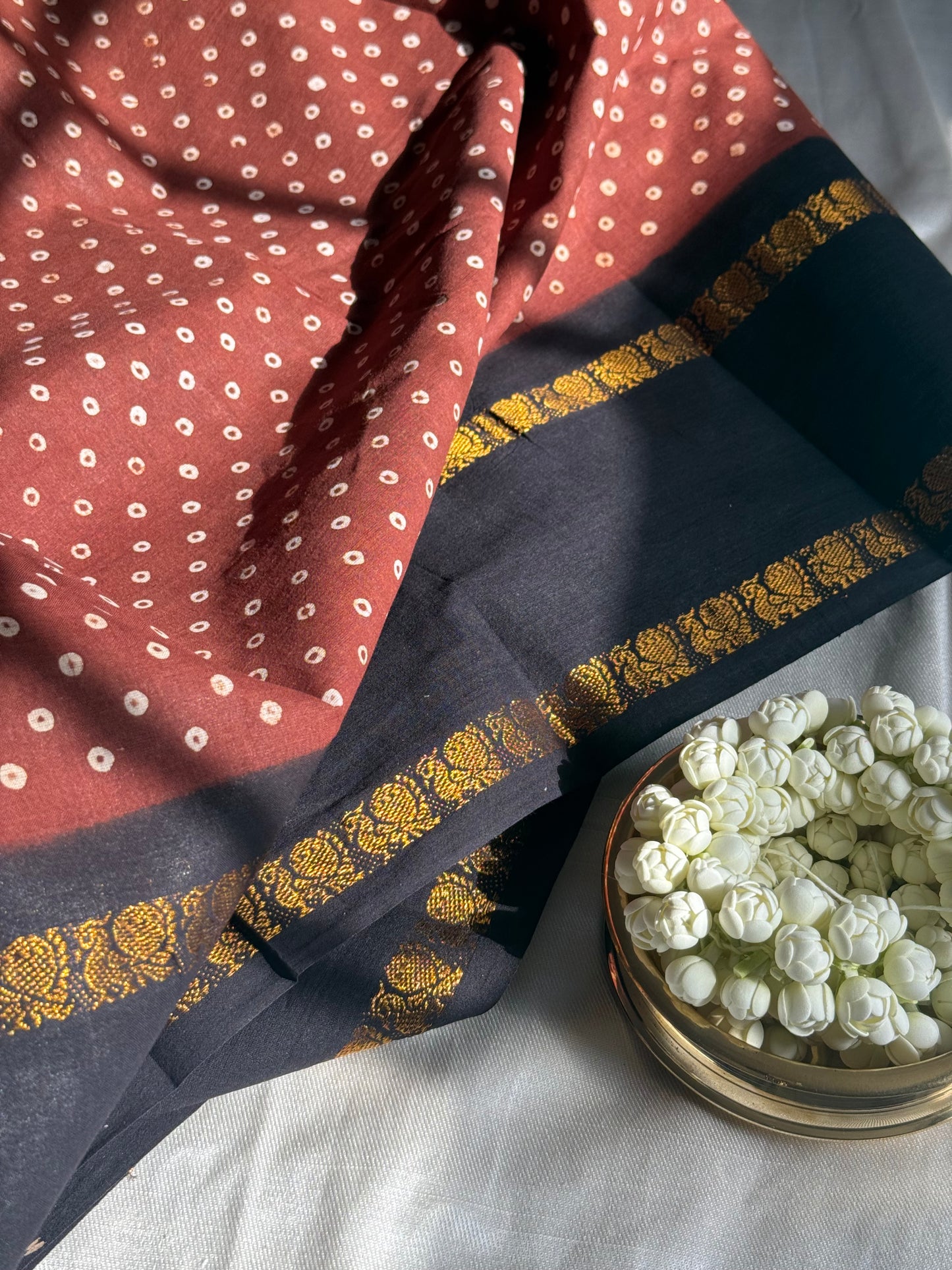 Madurai Sungudi cotton saree folded to show self rettapet border and wax-resist body