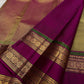 Magenta border detail on a champagne gold Kanchipuram saree.