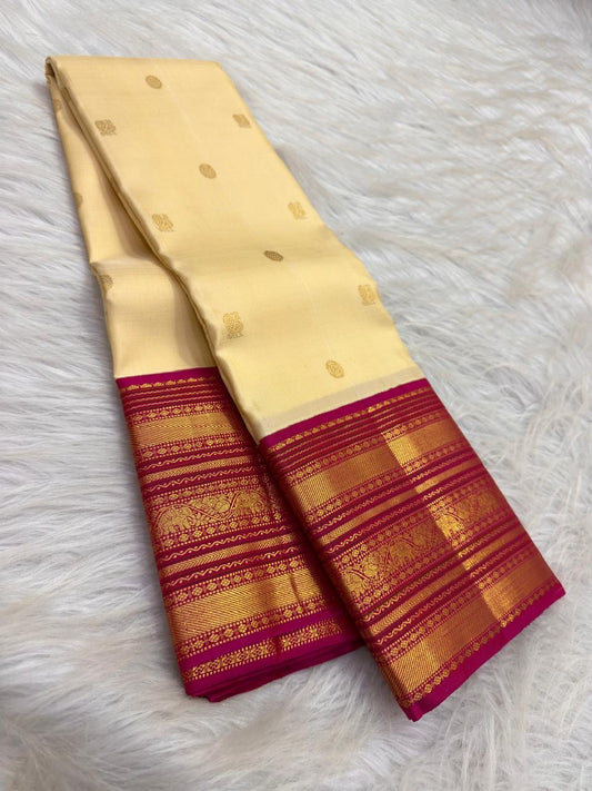 Warm ivory handwoven pure silk Kanjipuram Varisaipet saree with a magenta border