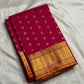 Magenta silk surface with repeating gold zari kamalam lotus butta detail