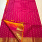 Wide golden zari geometric border on magenta Kanchi Pattu saree