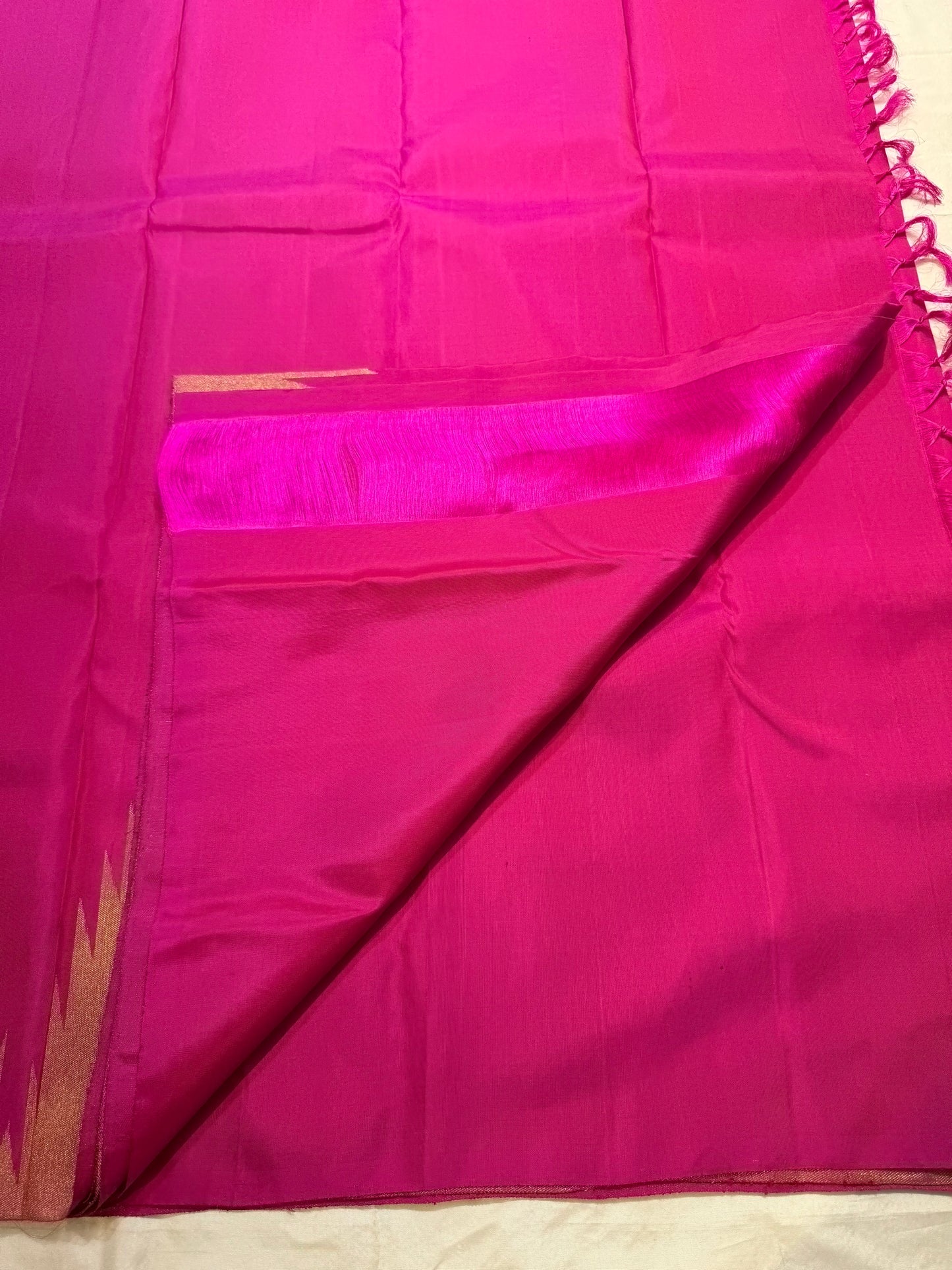 Full magenta Kanjivaram saree with Ettukol border, folded view