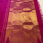 Gold Ettukol zari flame-edged border close-up on magenta Kanjivaram saree