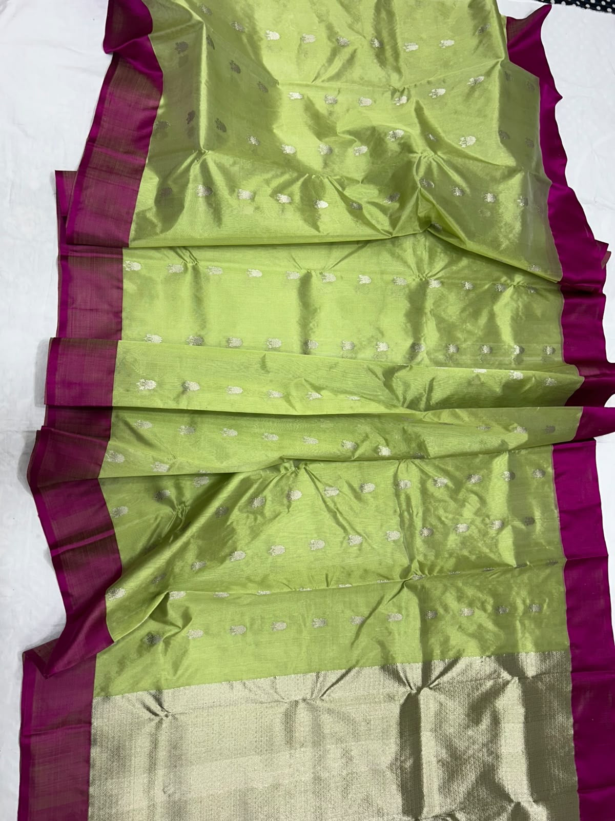 Rich magenta border framing the luminous lime green body of a Chanderi saree.