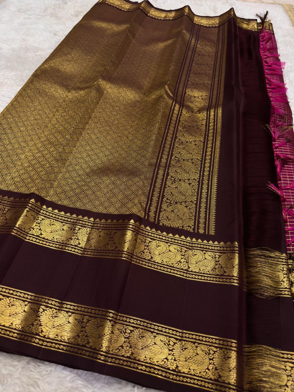 Handwoven magenta Zari Kattam saree with deep brown contrast border and traditional Mayil zari motifs.