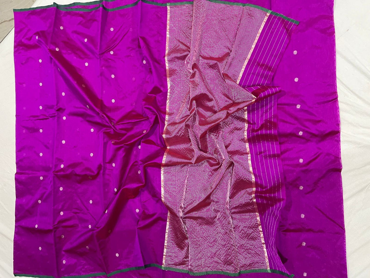 Draped magenta Pattu Silk Chanderi saree showing luminous metallic striped pallu and deep green edging