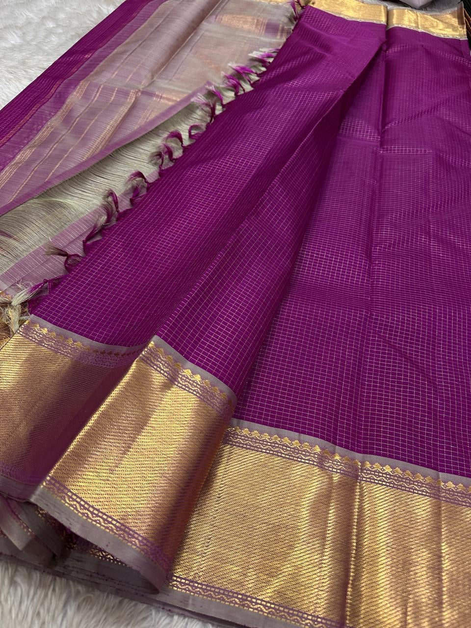 Heavy Getti gold-zari border on a magenta Kanchipuram saree.