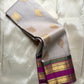 Pearl silver pure Kanchipuram silk saree draped to show gold paisley buttas and magenta zari border