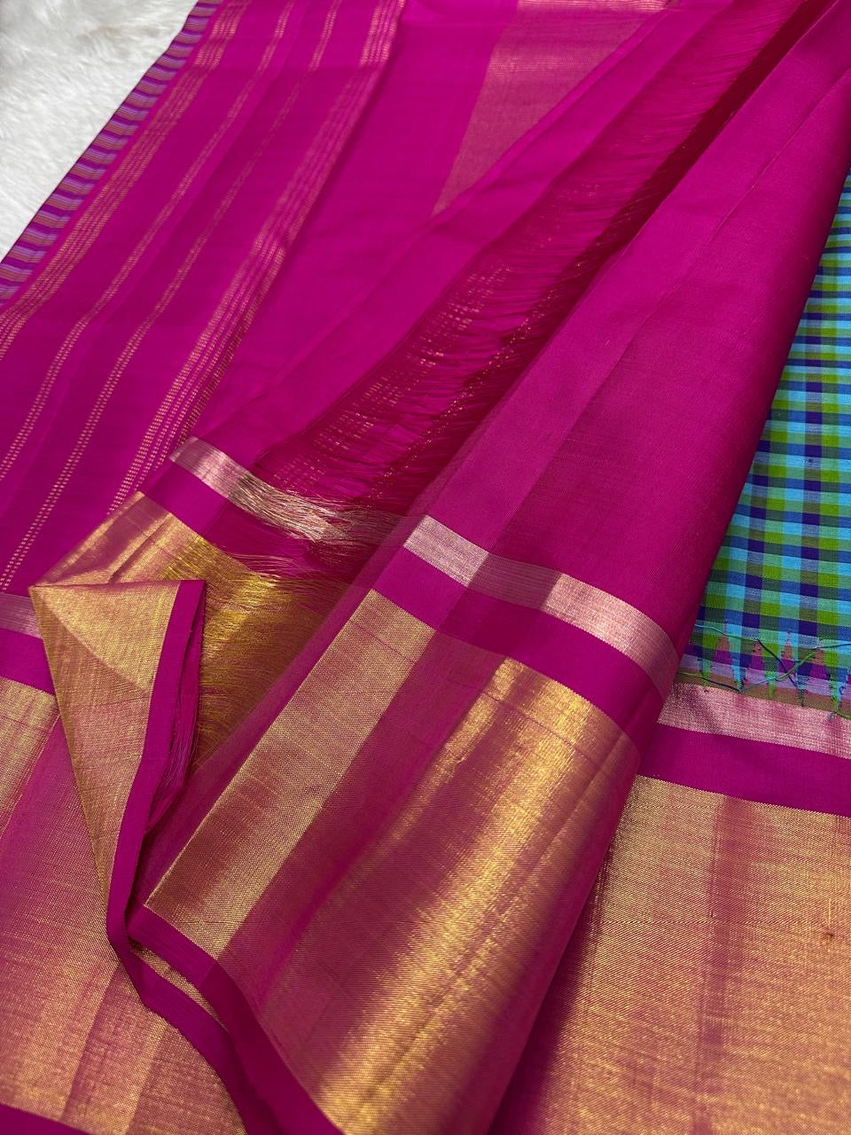 Full pallu view in magenta with gold zari stripes and a wide gold zari panel near the border (available in the USA)