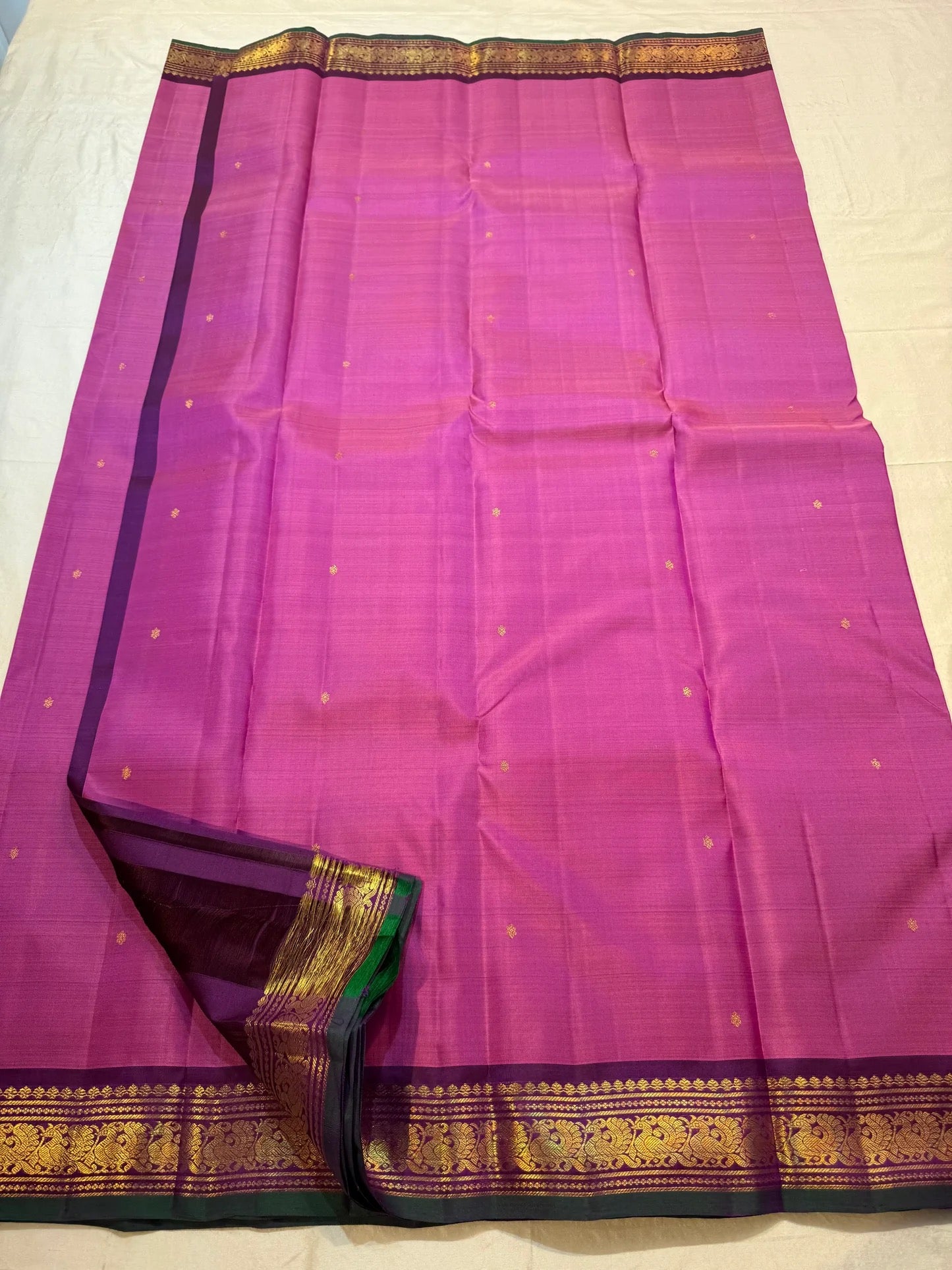Gold zari floral butta detail on magenta Korvai saree body