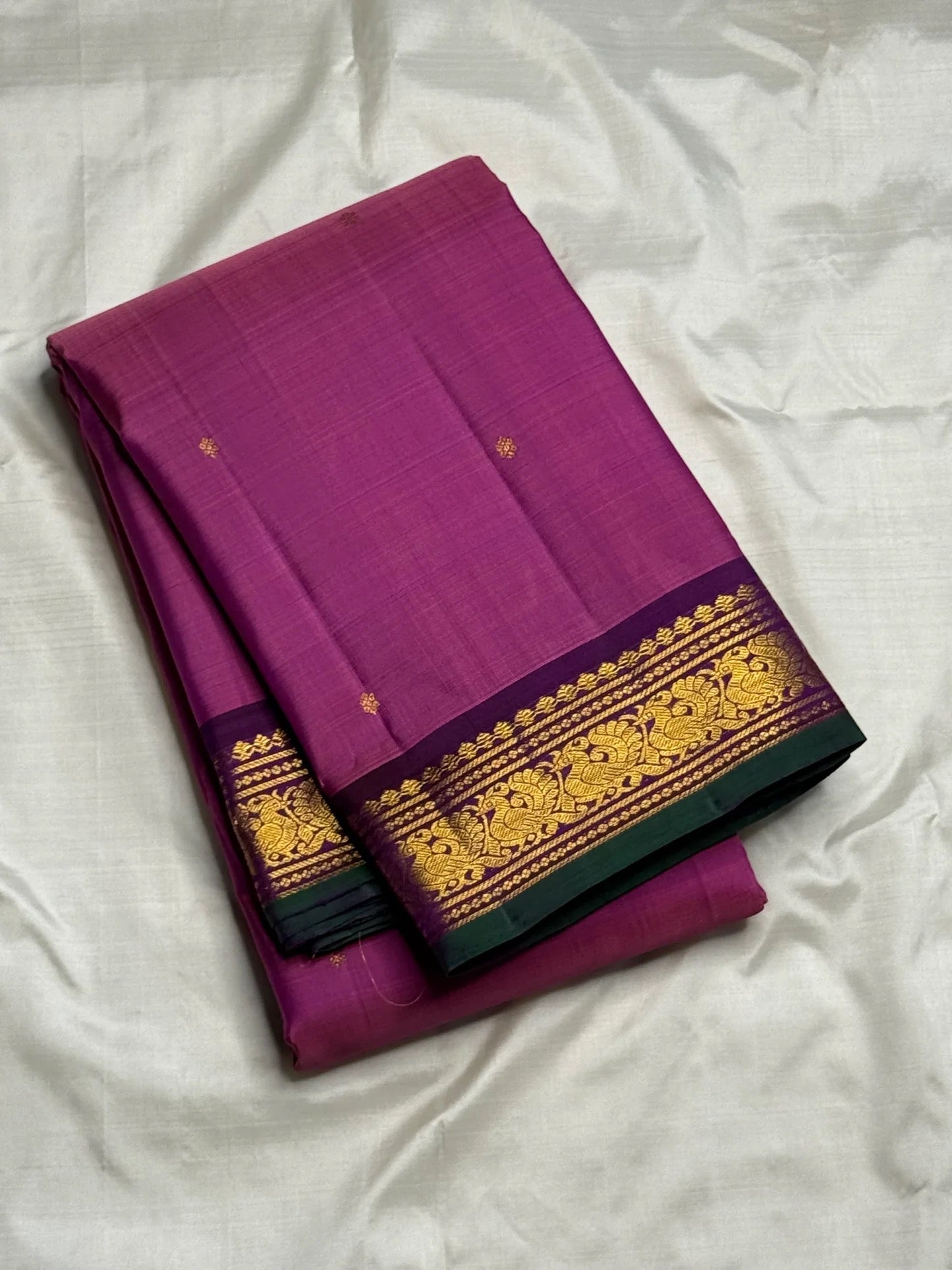 Purple-green petite peacock pallu detail on magenta saree