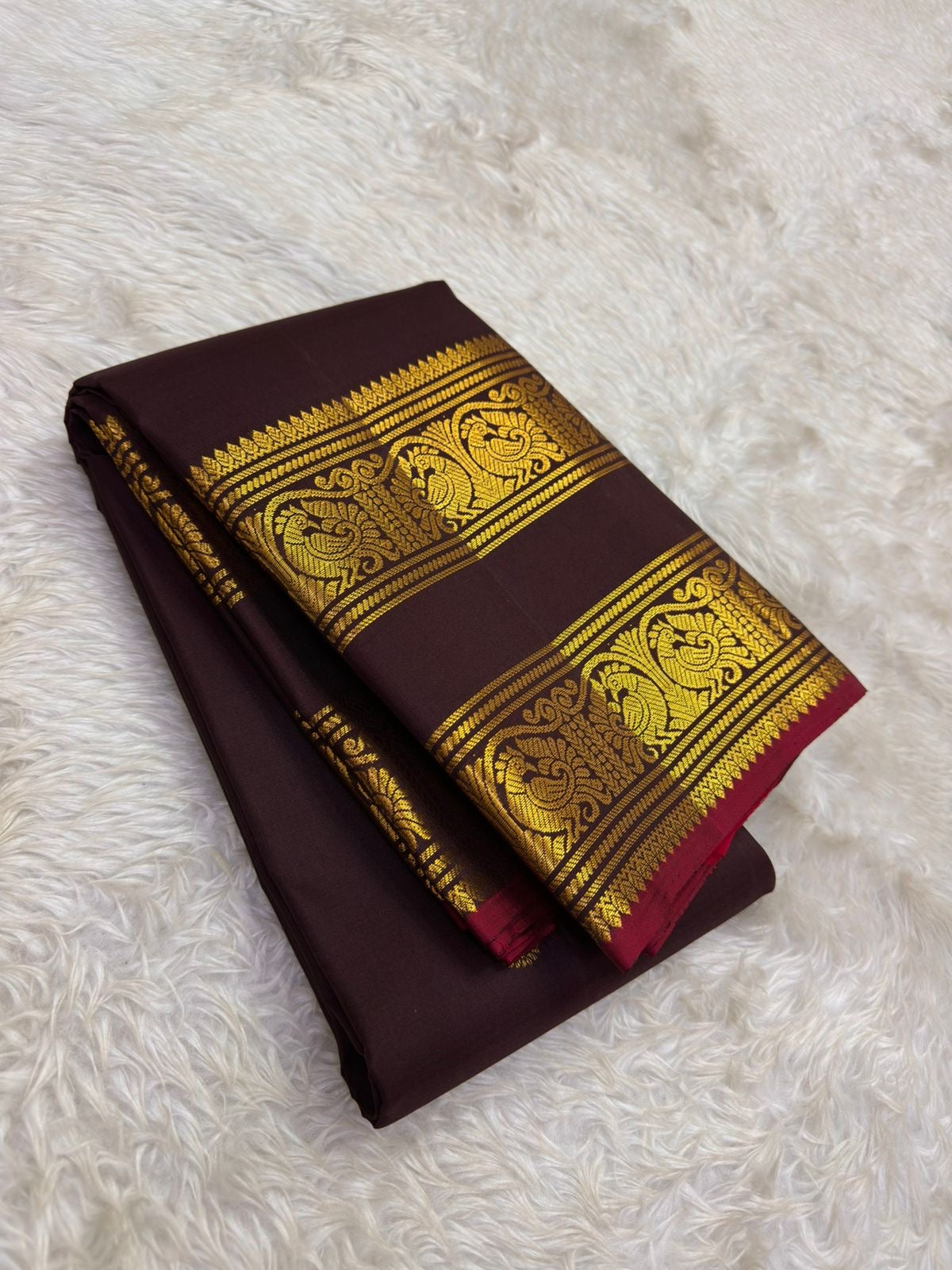 Self-colour pallu of deep wine plum Kanjipuram pure silk saree with cascading Maanga and Yaanai antique gold zari