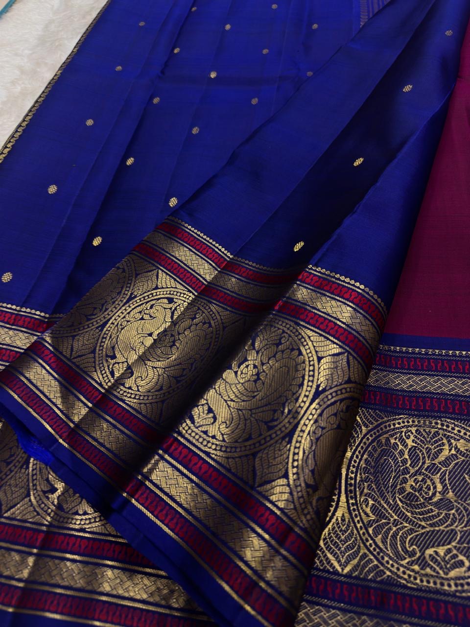 Magenta pink Kanchipattu saree with sorgavaasal mayil peacock motif detail