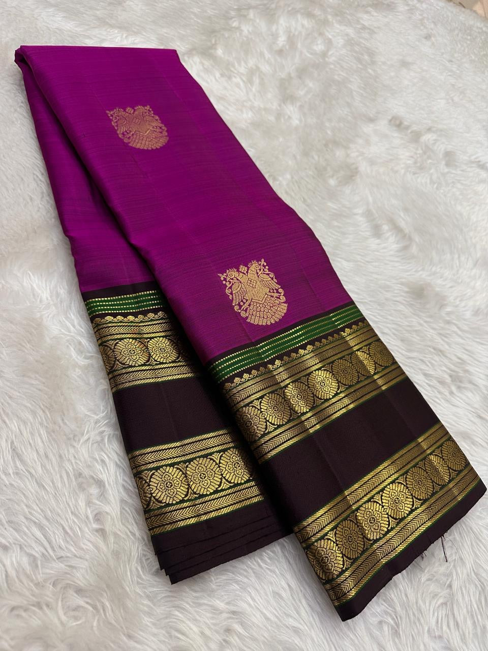 Handwoven pure silk Kanjivaram rettapet saree in magenta pink with larger gold buttas and a luminous tissue pallu.